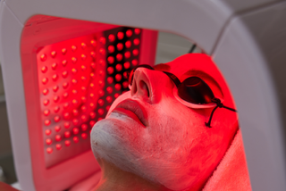 Red LED therapy close-up showing wavelengths that stimulate collagen and reduce inflammation
