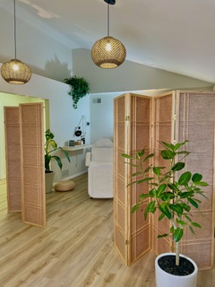 Hanging lights and rattan dividers creating a calm studio atmosphere