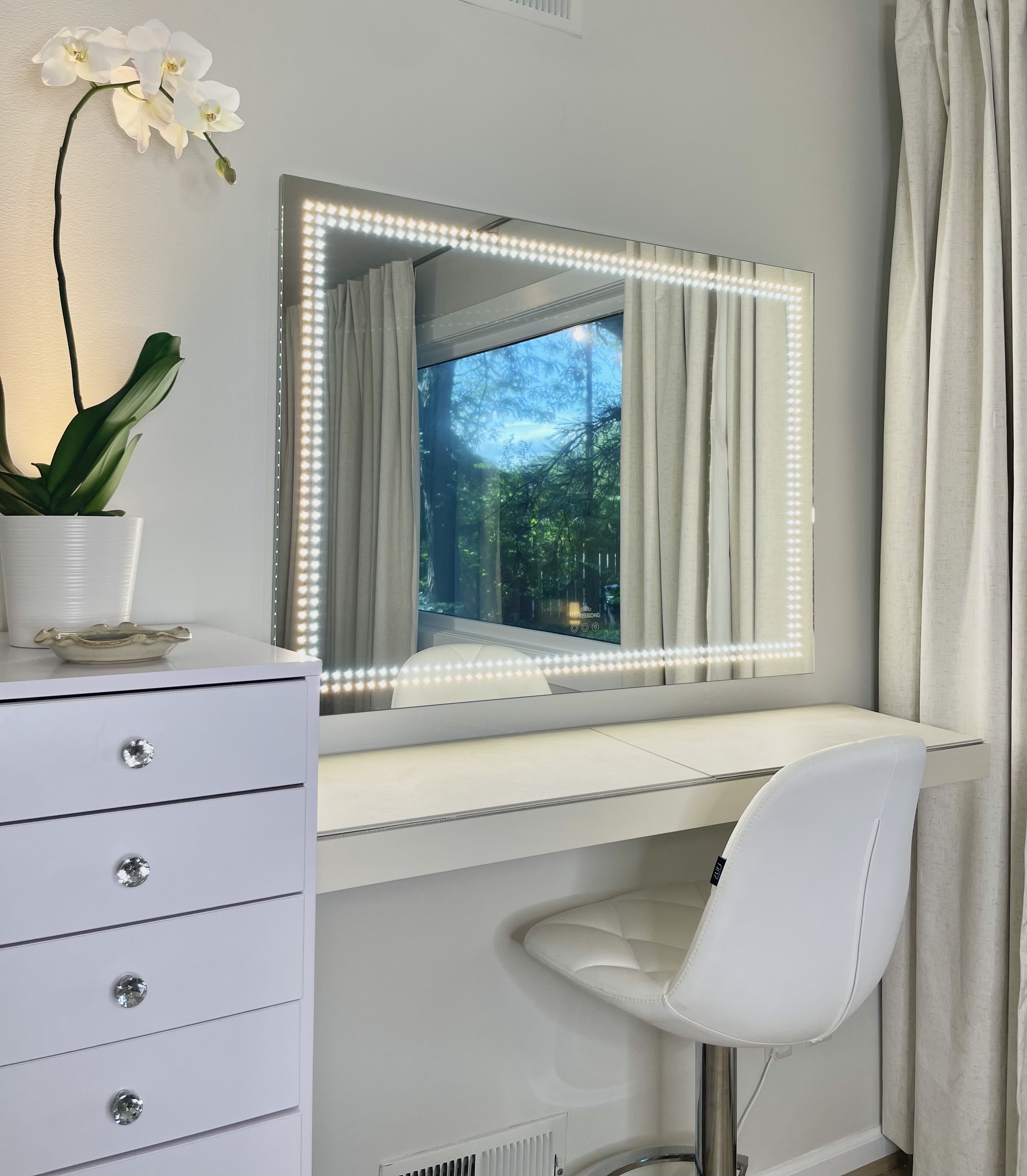 Vanity area with lighted mirror at The Skin Tune studio